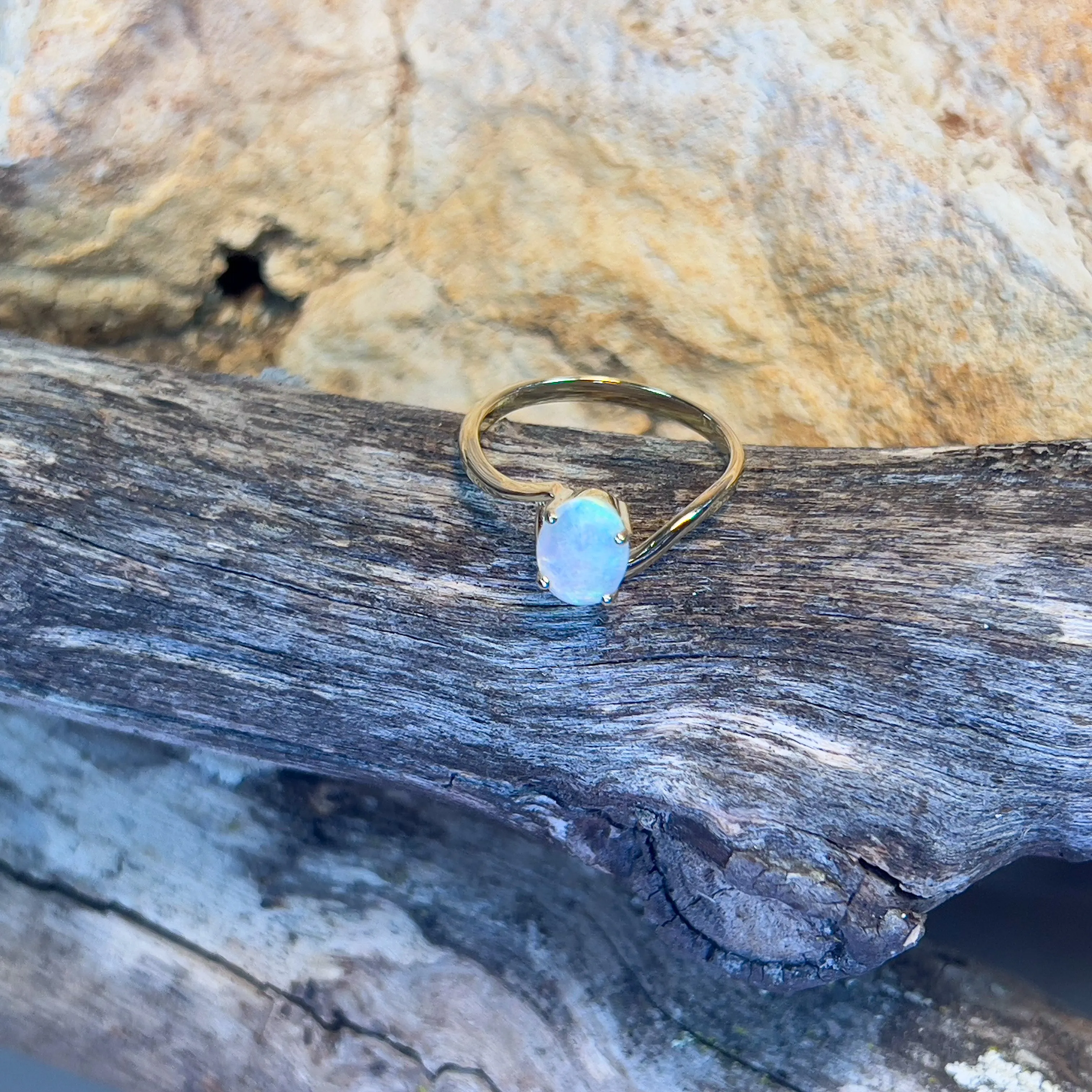 14kt Yellow Gold crossover ring with one 0.55ct Crystal Opal