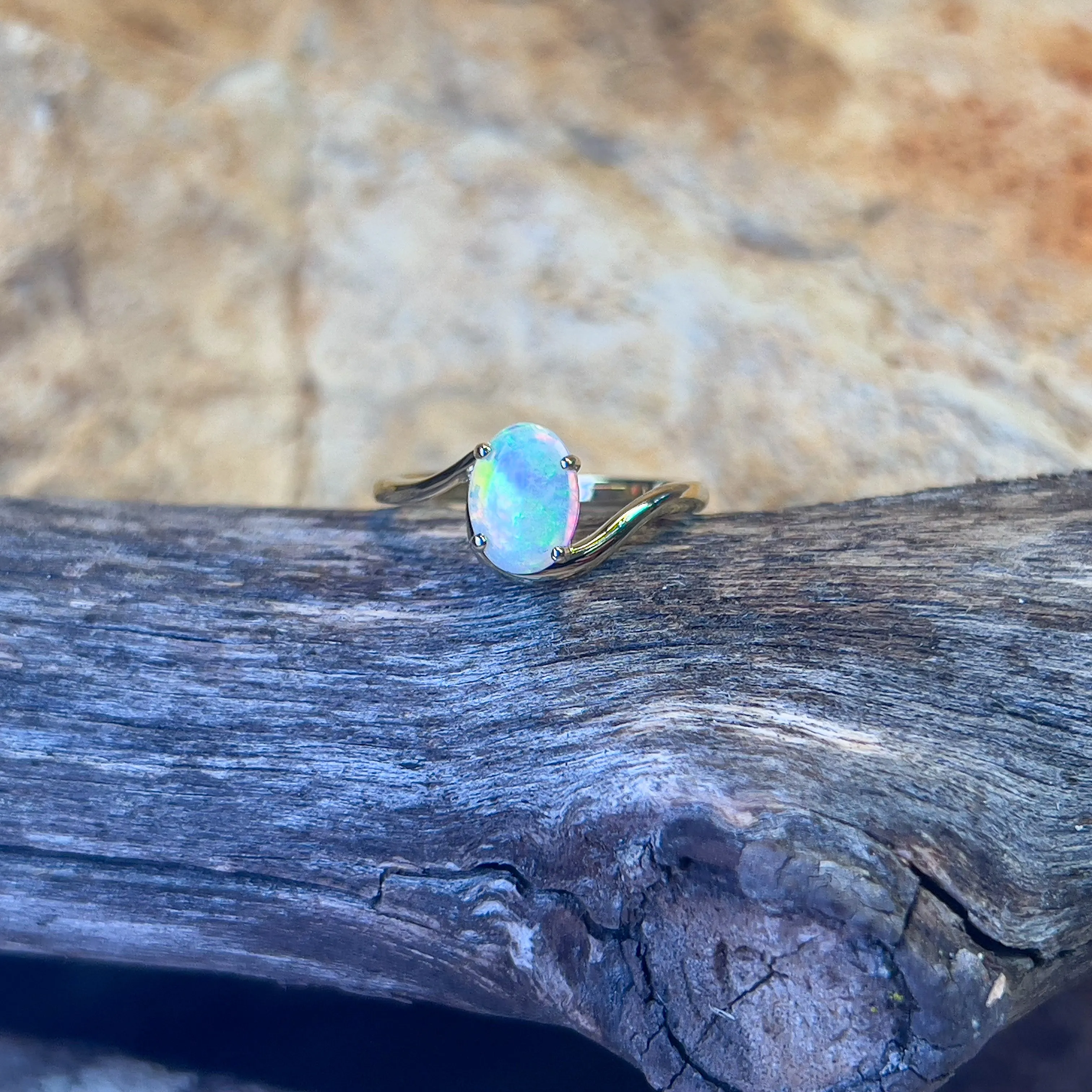 14kt Yellow Gold crossover ring with one 0.55ct Crystal Opal