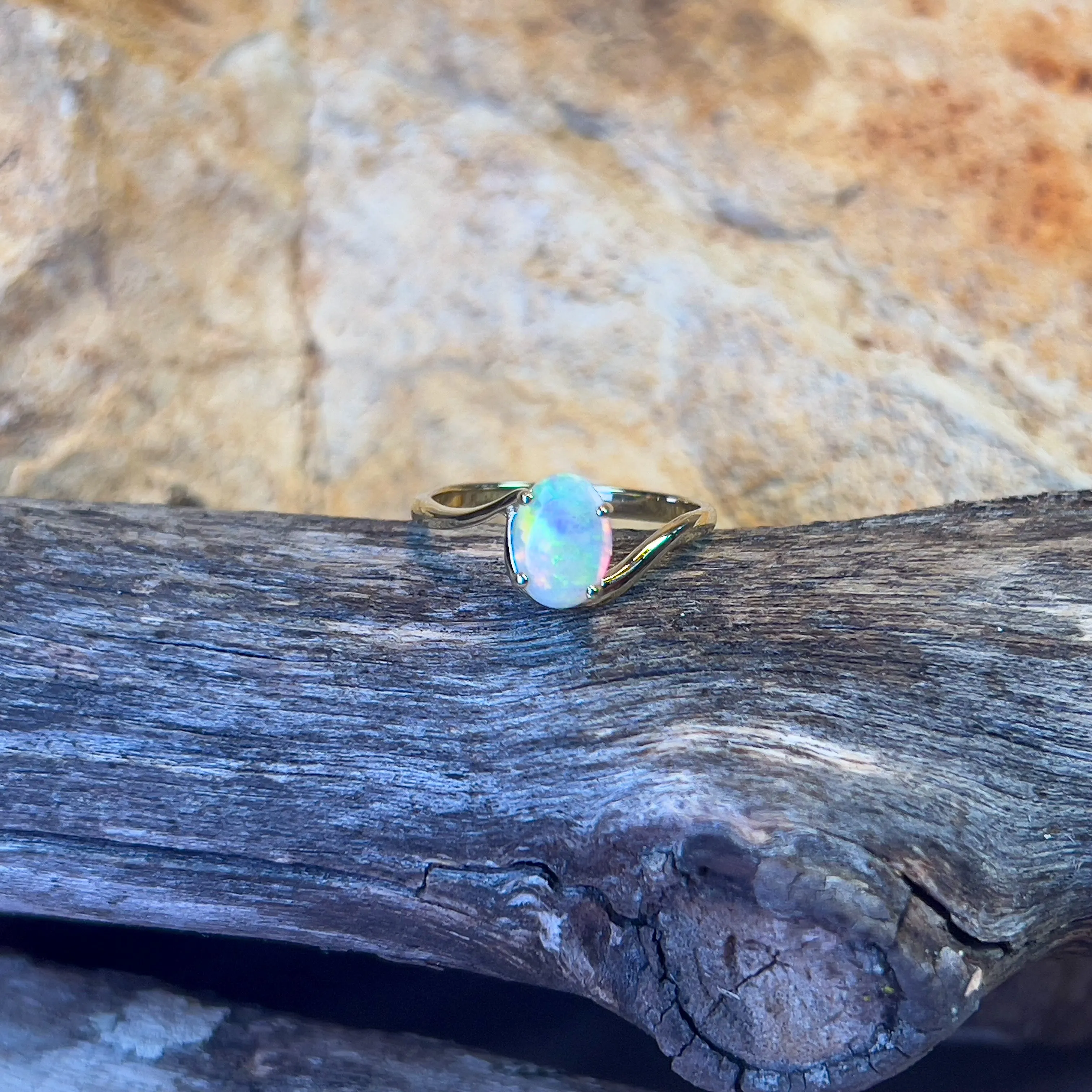 14kt Yellow Gold crossover ring with one 0.55ct Crystal Opal