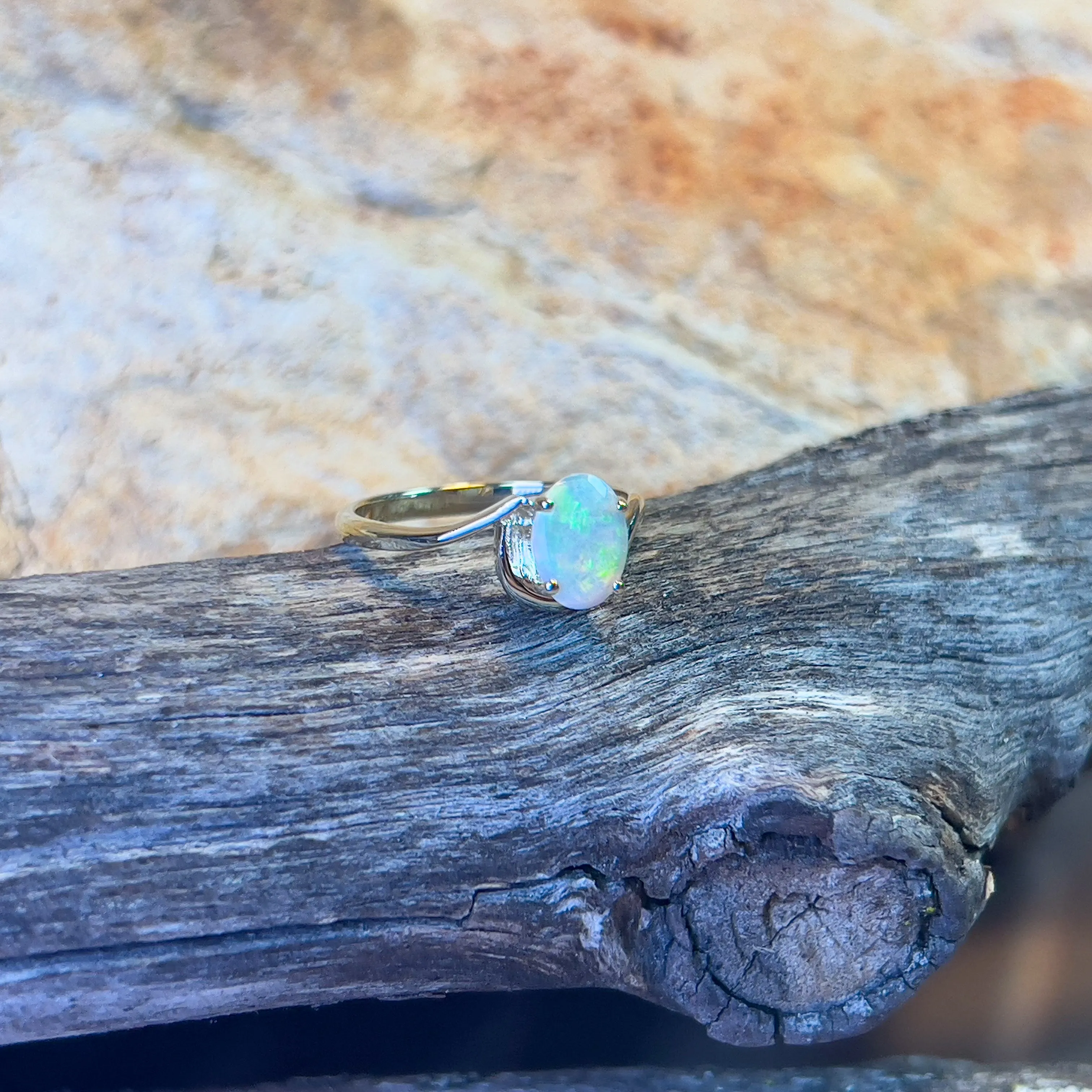 14kt Yellow Gold crossover ring with one 0.55ct Crystal Opal