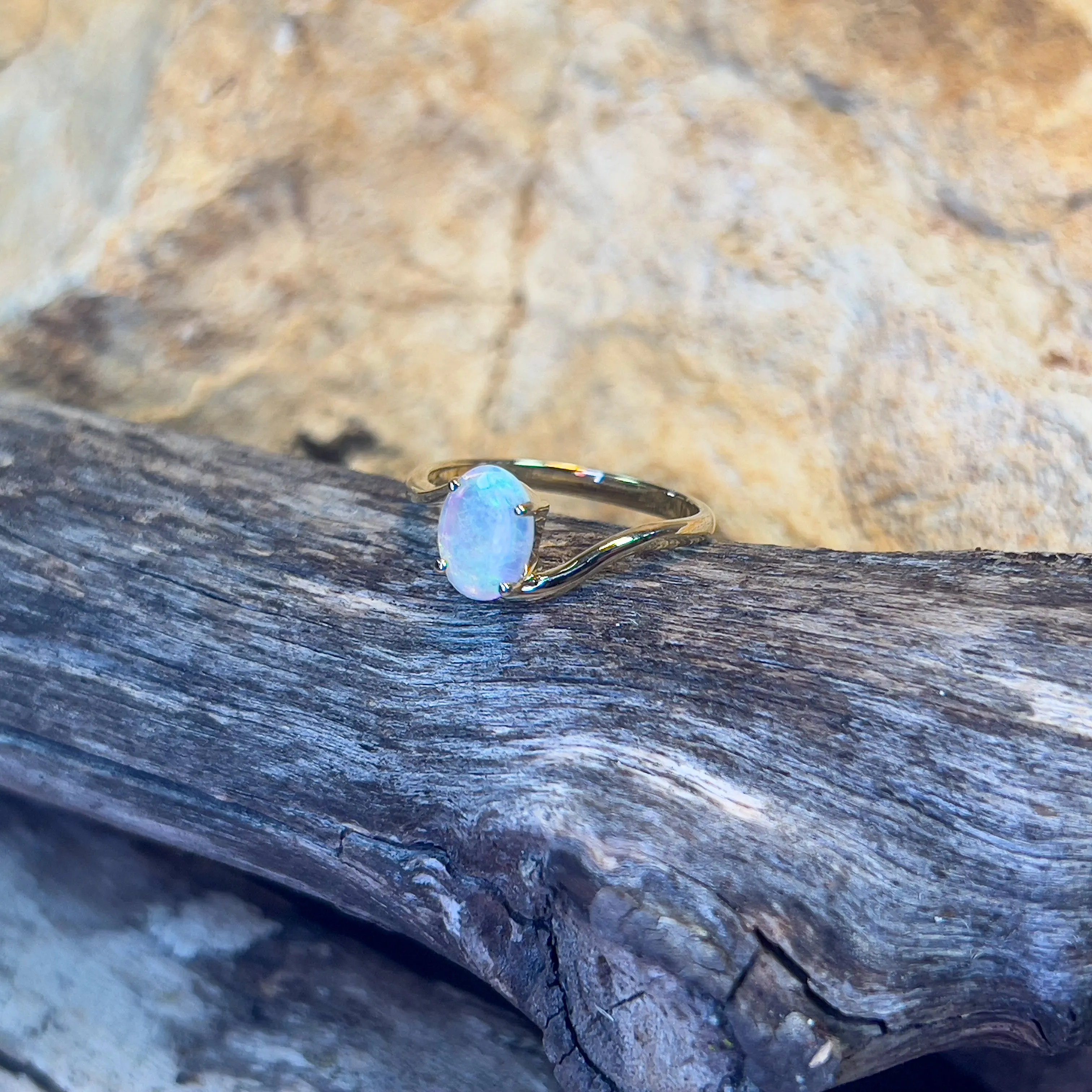 14kt Yellow Gold crossover ring with one 0.55ct Crystal Opal